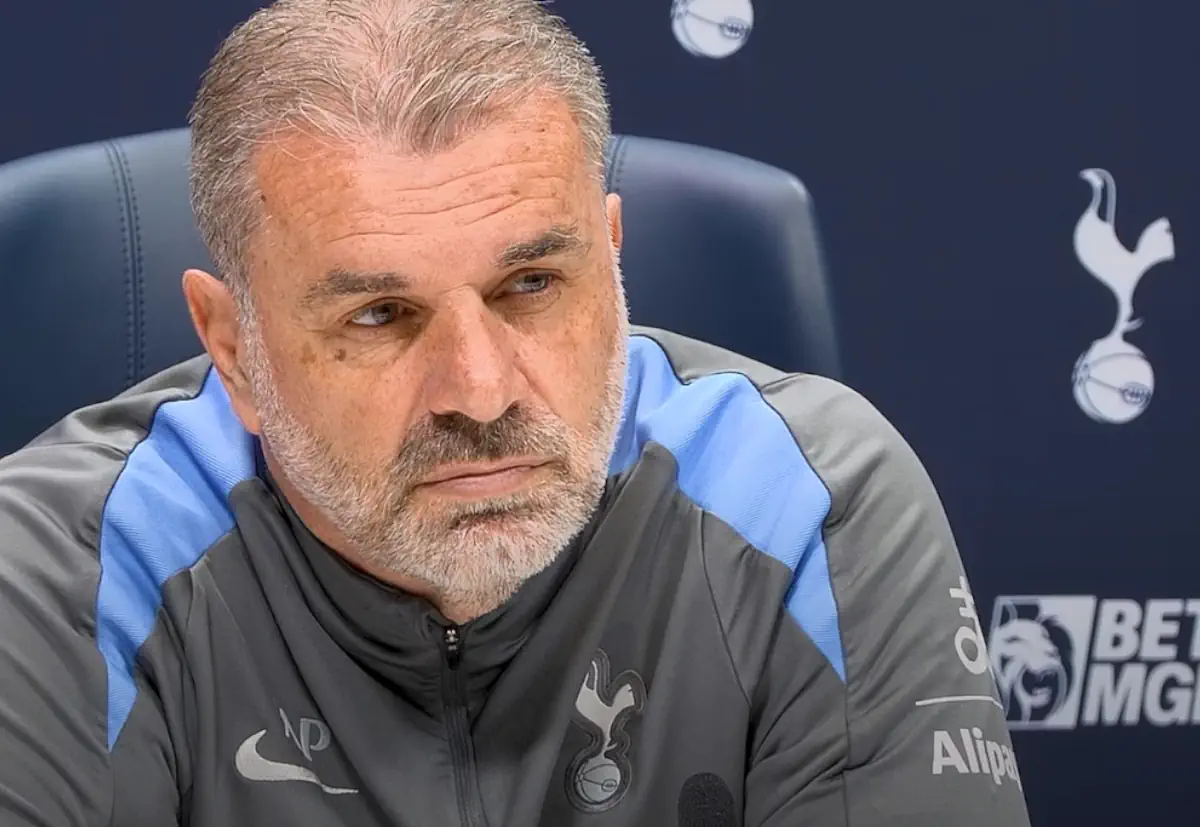 Ange Postecoglou listens to a question at a press conference
