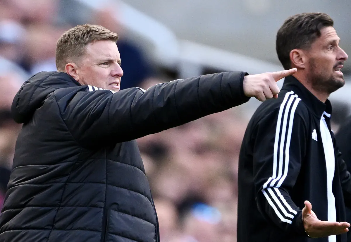 Eddie Howe points towards the pitch during a game