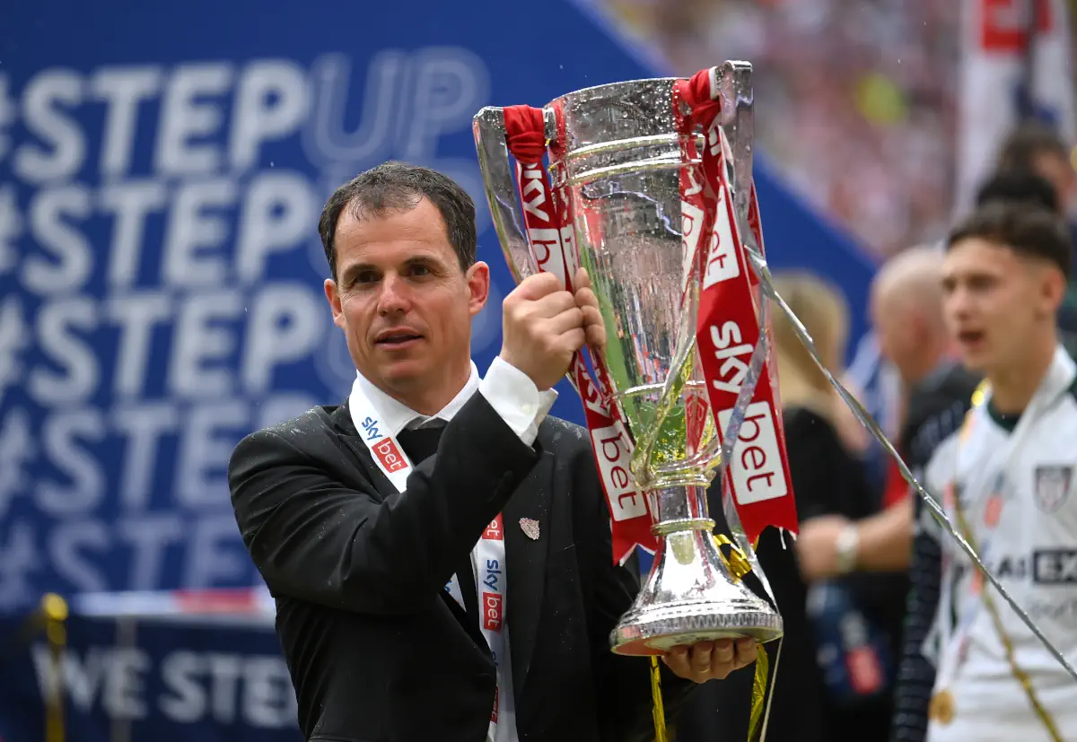 Sunderland manager Regis Le Bris holds the Championship playoff trophy aloft
