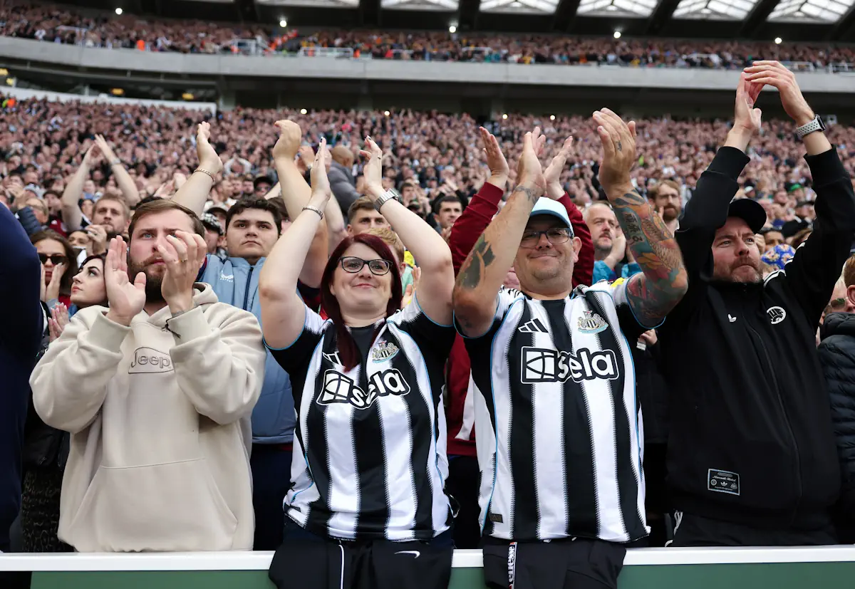 Newcastle United fans applaud the side