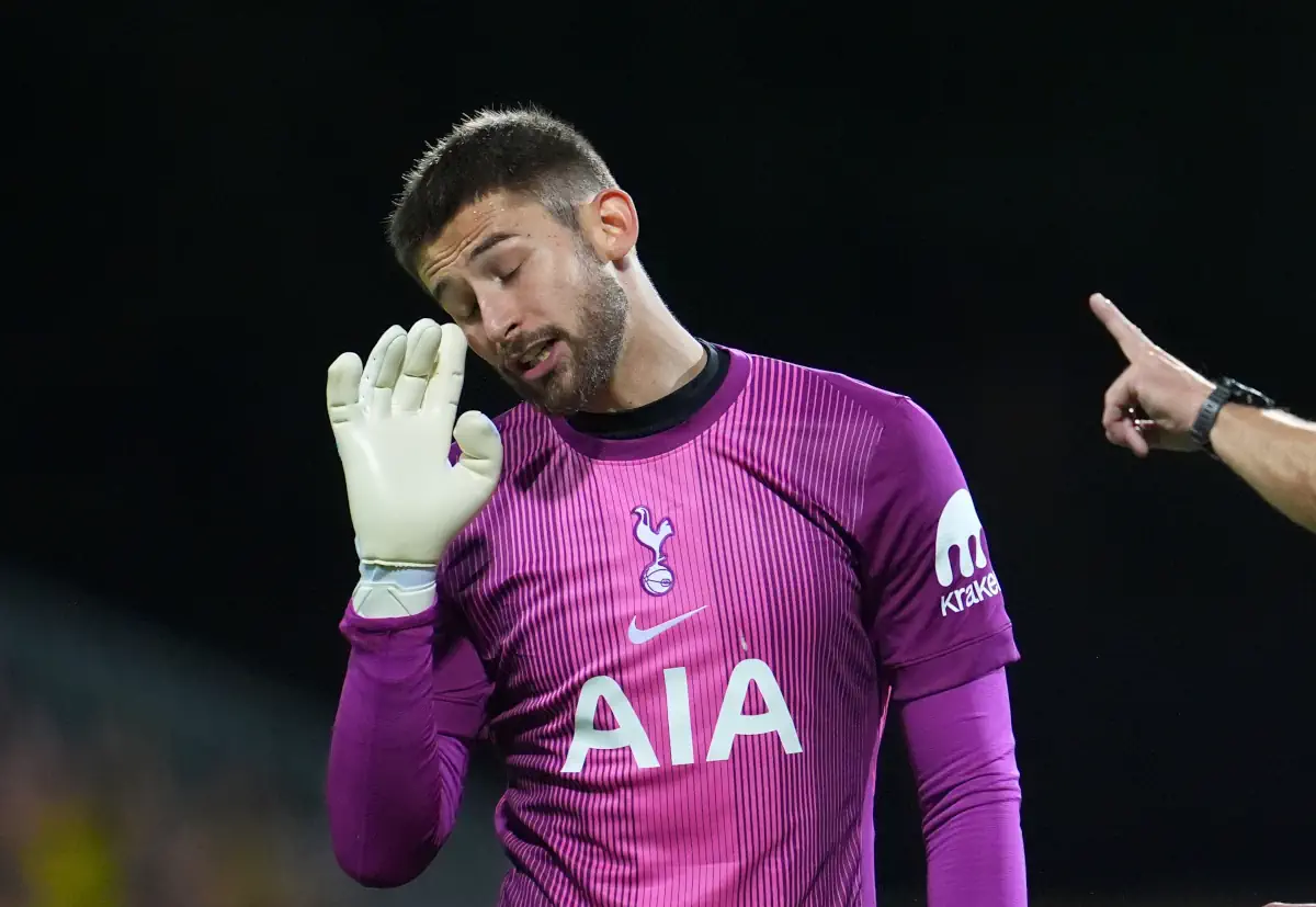 Tottenham goalkeeper Guglielmo Vicario holds up his hand towards the referee in disbelief